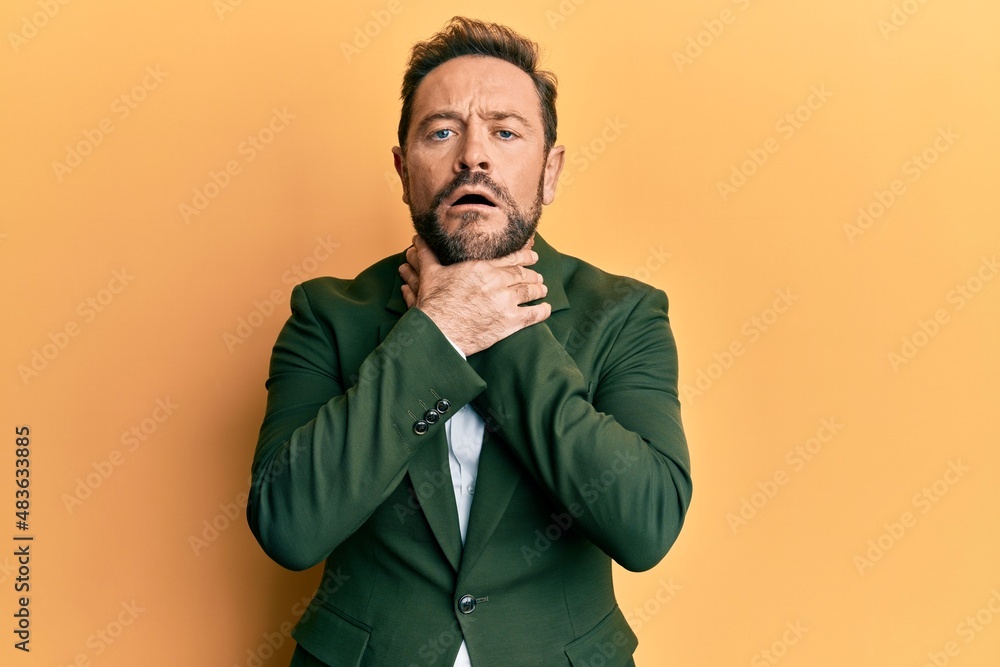 Middle age man wearing business suit shouting and suffocate because painful strangle. health problem. asphyxiate and suicide concept. Middle age man wearing business suit shouting and suffocate because painful strangle. health problem. asphyxiate and suicide concept.
