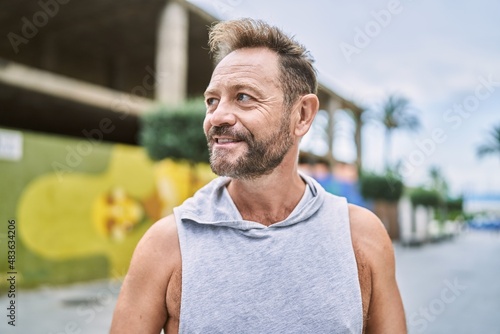 Middle age man smiling confident at the city