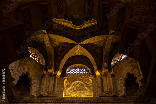 CORDOBA, SPAIN - August 11, 2021: mosaic-decorated archs in the Mosque-Cathedral of Cordoba,  Andalusia, former Islamic mosque, it is also known as the Mezquita. One of Symmetric image. photo