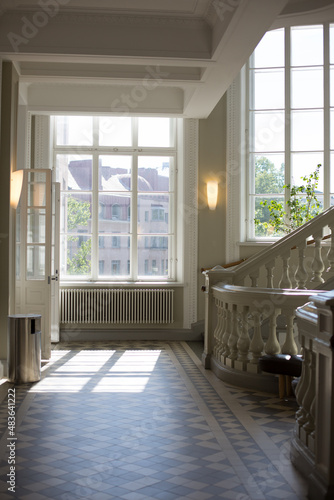 Bright classic stairway with wall lights