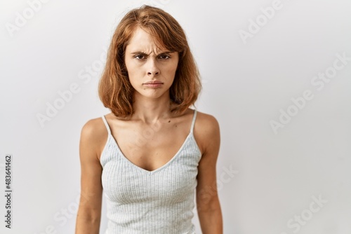 Beautiful caucasian woman standing over isolated background skeptic and nervous, frowning upset because of problem. negative person.