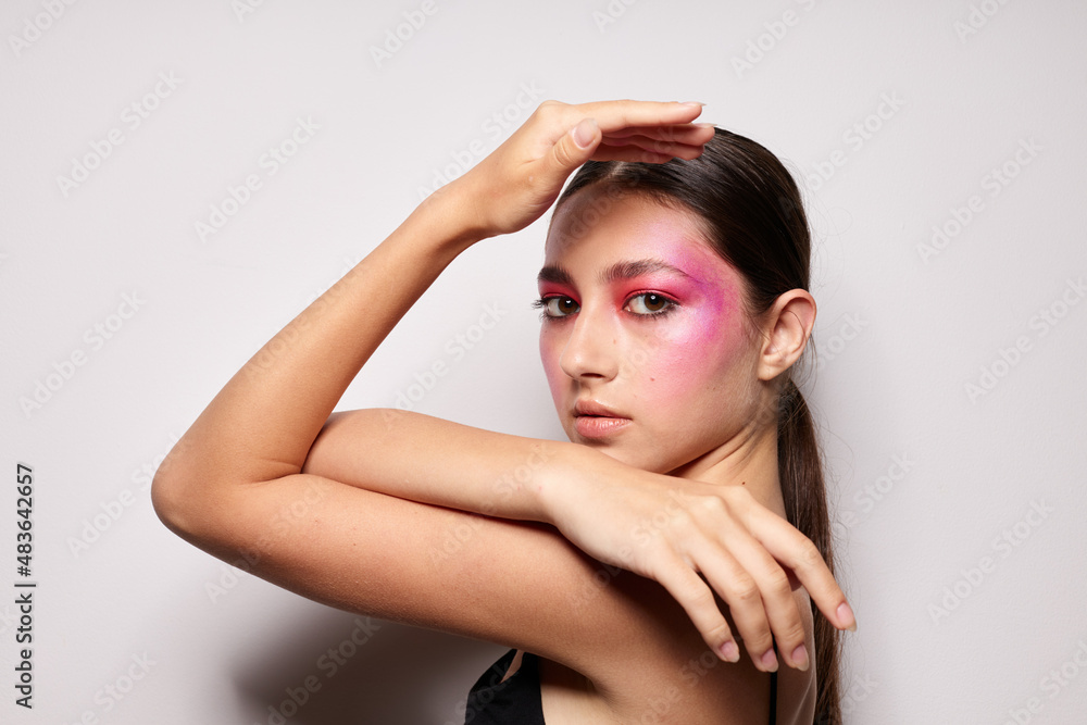Young beautiful woman bright makeup posing fashion emotions isolated background unaltered Young beautiful woman bright makeup posing fashion emotions isolated background unaltered