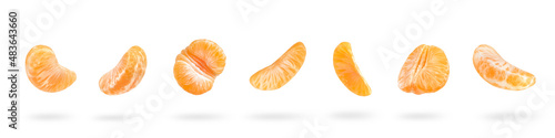 A large set of mandarin slices isolated on a white background falling down casting a shadow. Separate tangerine slices to insert into a project or design
