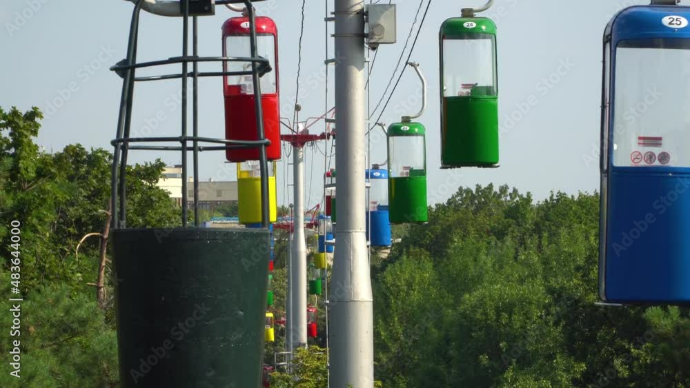 The cable way with different colored cabins at the public park. The cable way with different colored cabins at the public park.