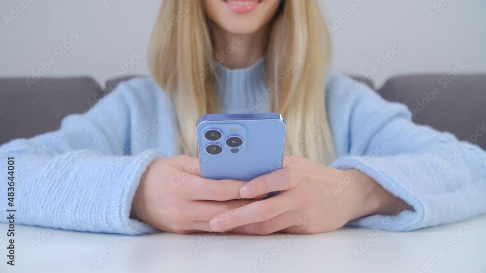 Typing message online in social media app on modern blue mobile phone with triple camera. Cheerful white woman using new smartphone gadget for communication in 4k stock footage Typing message online in social media app on modern blue mobile phone with triple camera. Cheerful white woman using new smartphone gadget for communication in 4k stock footage