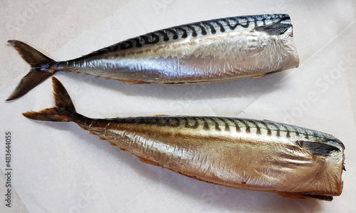 Smoked Mackerel. Two fatty whole gutted fish without heads on plain wrapper paper