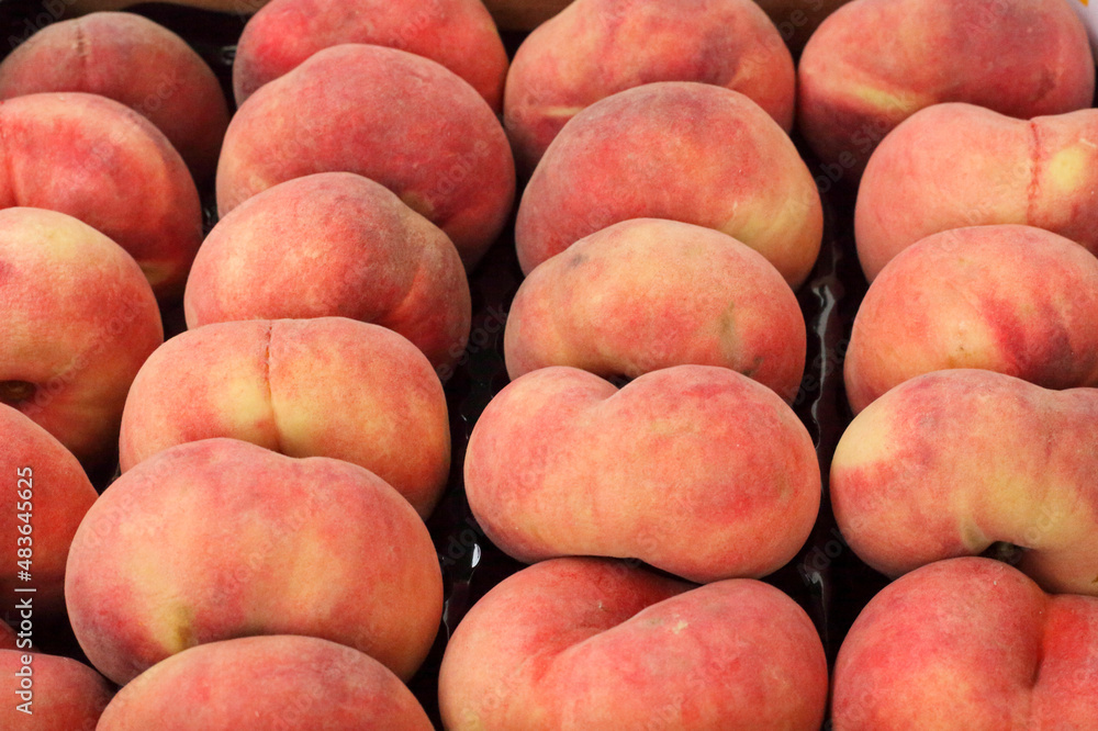 Fresh organic flat peaches at the market Fresh organic flat peaches at the market