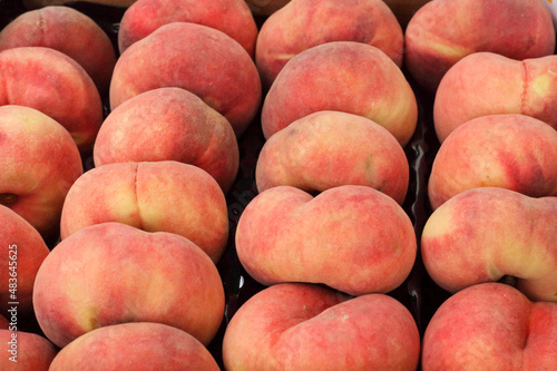 Fresh organic flat peaches at the market photo