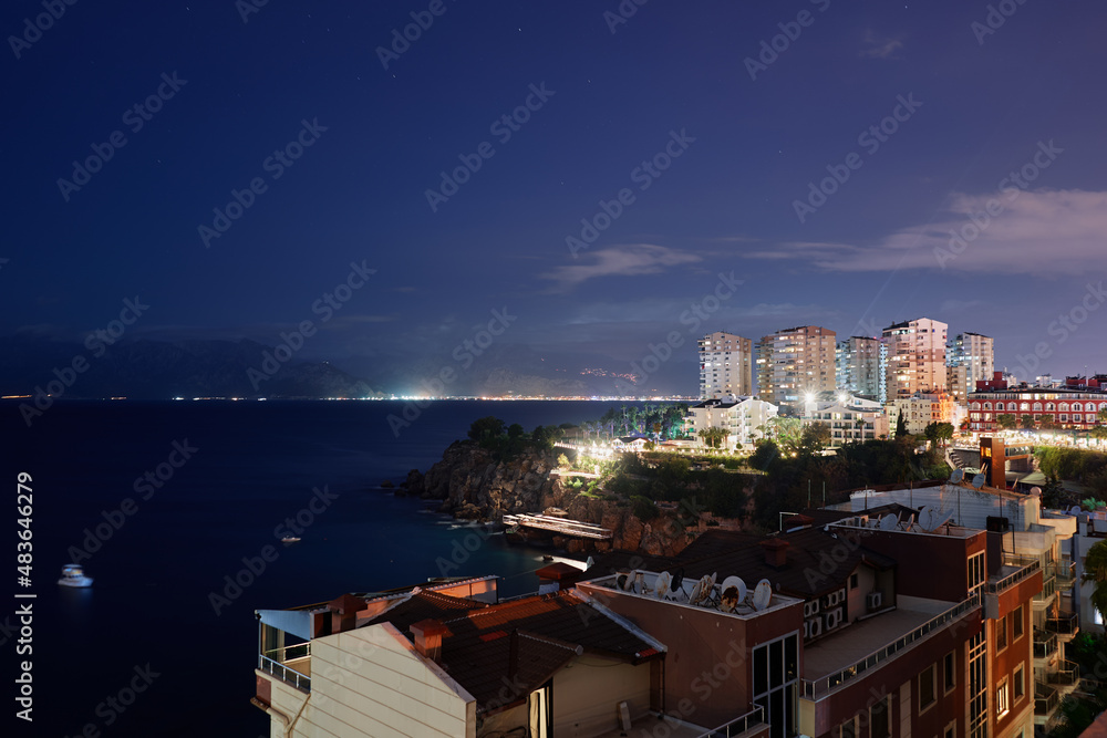 Beautiful night landscape with city on the seashore. Antalya, Turkey.