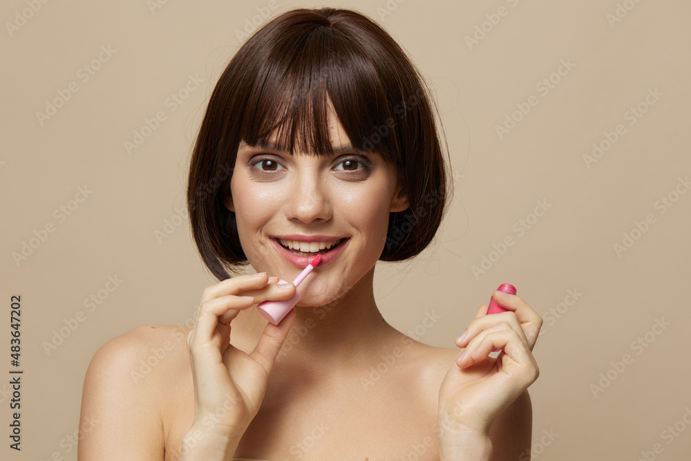 beautiful woman makeup lip gloss near the face bare shoulders cropped view beautiful woman makeup lip gloss near the face bare shoulders cropped view