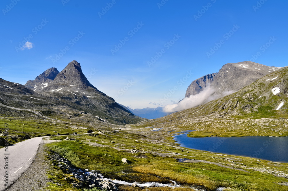 High rocky mountains, lake and road in Romsdal region, Norway