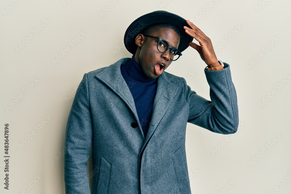 Young african american man wearing elegant style surprised with hand on head for mistake, remember error. forgot, bad memory concept. Young african american man wearing elegant style surprised with hand on head for mistake, remember error. forgot, bad memory concept.