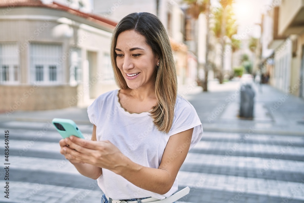Young hispanic woman smiling confident using smartphone at street Young hispanic woman smiling confident using smartphone at street