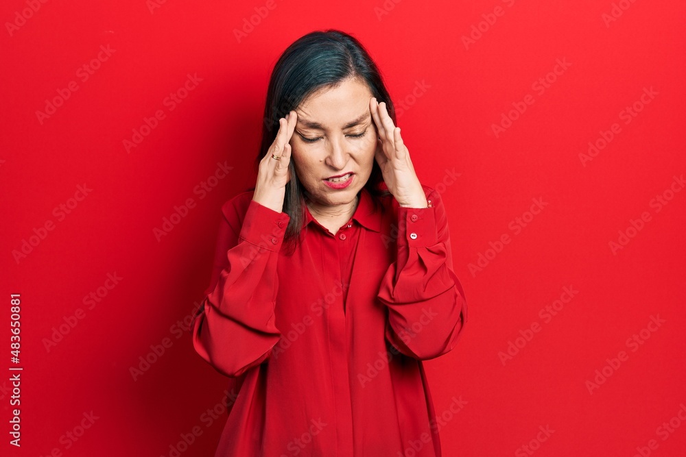 Middle age hispanic woman wearing casual clothes with hand on head, headache because stress. suffering migraine. Middle age hispanic woman wearing casual clothes with hand on head, headache because stress. suffering migraine.