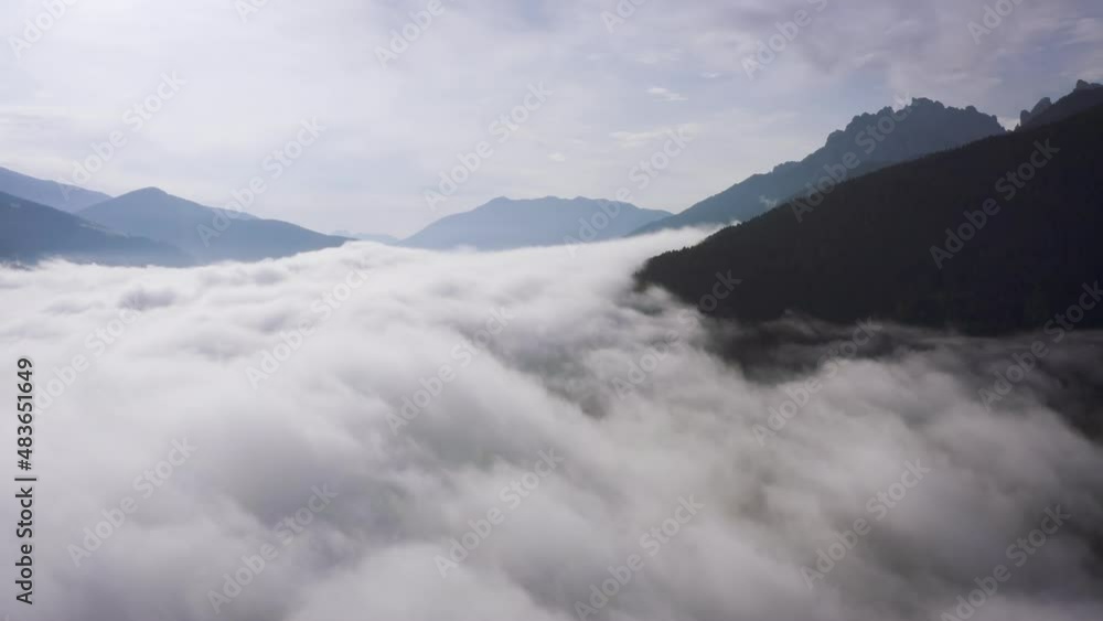 Flying through clouds above mountain tops. High peaks wonderful morning sunrise natural Landscape Flying through clouds above mountain tops. High peaks wonderful morning sunrise natural Landscape
