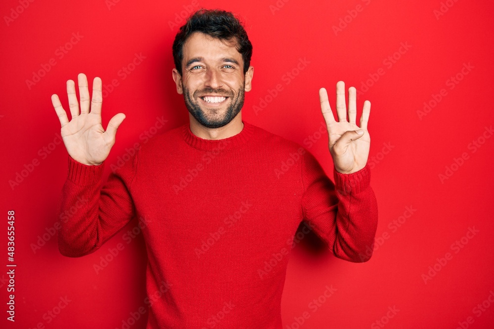 Handsome man with beard wearing casual red sweater showing and pointing up with fingers number nine while smiling confident and happy. Handsome man with beard wearing casual red sweater showing and pointing up with fingers number nine while smiling confident and happy.