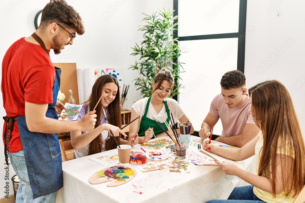 Obraz premium Group of people smiling happy drawing sitting on the table at art studio.