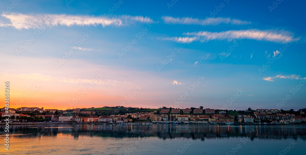 Spectacular autumn sunset, with the view of the town and the port of San Vicente de la Barquera. Cantabria, Spain.
