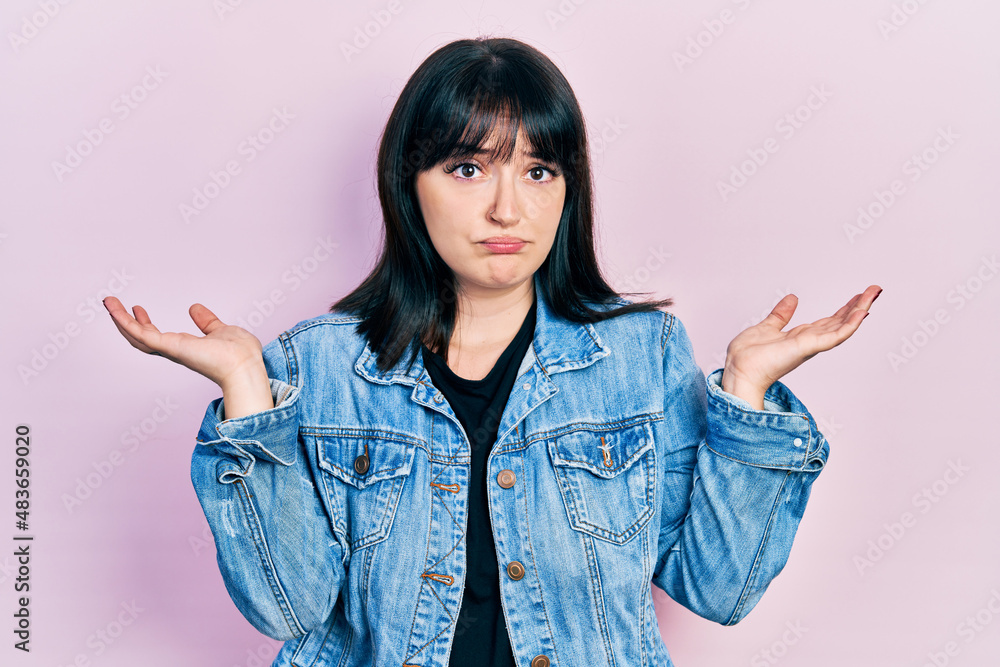Young hispanic woman wearing casual clothes clueless and confused with open arms, no idea and doubtful face. Young hispanic woman wearing casual clothes clueless and confused with open arms, no idea and doubtful face.