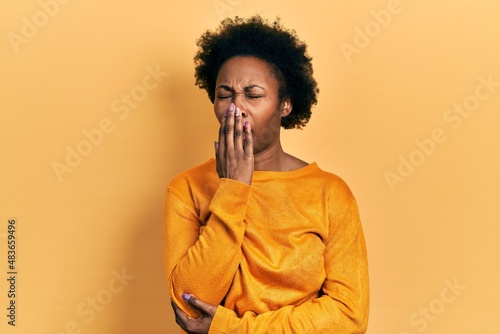 Young african american woman wearing casual clothes bored yawning tired covering mouth with hand. restless and sleepiness. © Krakenimages.com