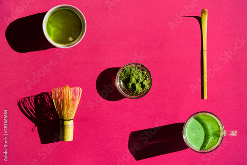 Background of matcha drink and powder with chasen and chashaku photo