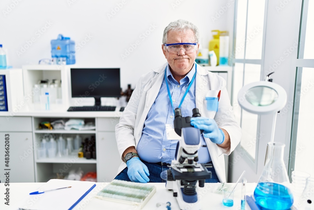 Senior caucasian man working at scientist laboratory skeptic and nervous, frowning upset because of problem. negative person. Senior caucasian man working at scientist laboratory skeptic and nervous, frowning upset because of problem. negative person.