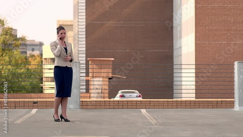 Businesswoman walks toward camera on the phone