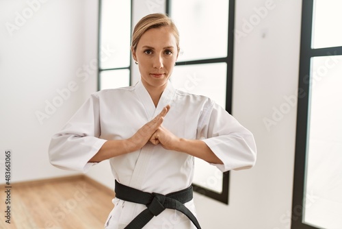 Young caucasian woman training karate at sport center