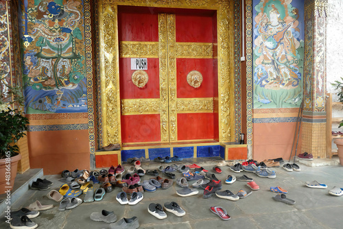 Shoes and sandals outside Kenchosum Lhakhang temple photo