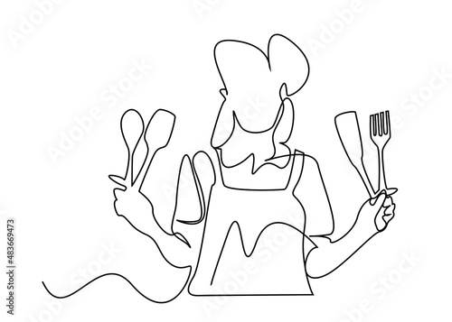 female cook posing holding kitchen supplies