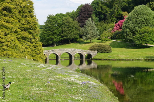 Riverside Lawn and Bridge in a Beautiful Country Park Garden