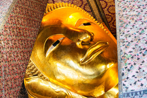 Famous Face of Golden Reclining Buddha Statue at Wat Pho Temple, One of Tourist Destination in Bangkok, Thailand 