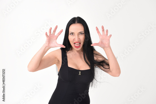 Fotografie Portrait of a beautiful brunette woman in an explosive fighting pose ready to fi