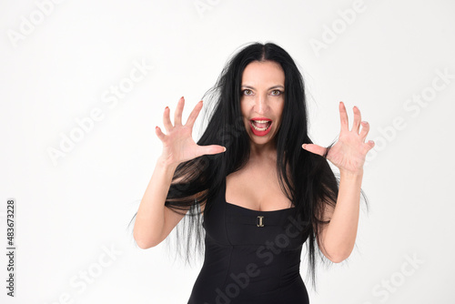 Obraz na płótnie Portrait of a beautiful brunette woman in an explosive fighting pose ready to fi
