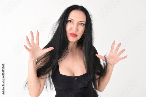 Obraz na płótnie Portrait of a beautiful brunette woman in an explosive fighting pose ready to fi