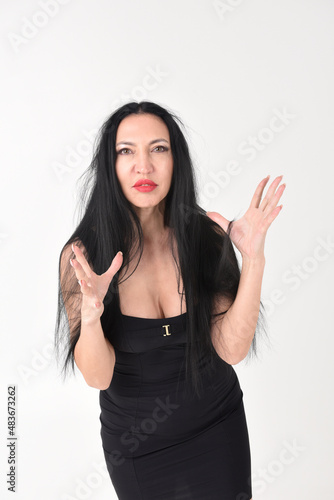 Obraz na płótnie Portrait of a beautiful brunette woman in an explosive fighting pose ready to fi