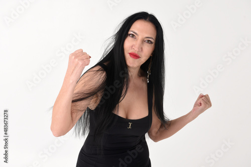 Obraz na płótnie Portrait of a beautiful brunette woman in an explosive fighting pose ready to fi