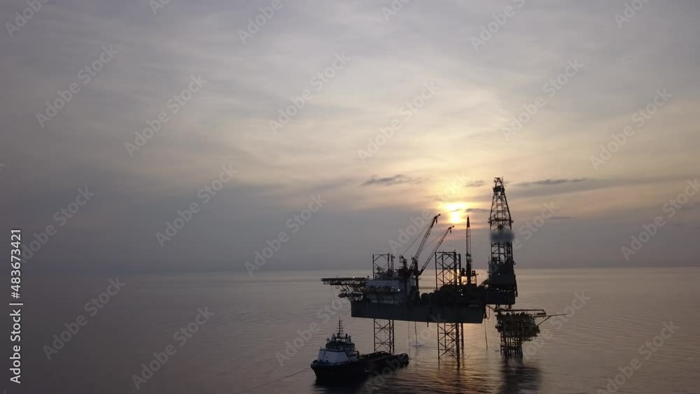Aerial view from a drone of an offshore jack up rig at the offshore location during sunrise time Aerial view from a drone of an offshore jack up rig at the offshore location during sunrise time