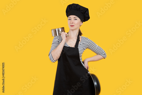 Chef with frying pans. Conf...