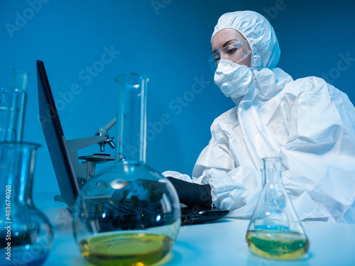 Scientist is typing on lapt...