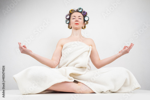 Yogi woman in curlers. Girl...