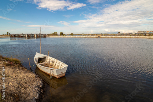 Fototapeta Naklejka Na Ścianę i Meble -  small wooden boat moored in the riverside area of ​​the city of Aveiro in Portugal