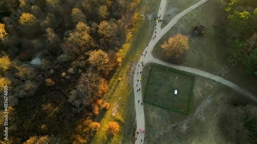 Group of runners running a marathon in a park at sunrise Przymorze Poland - aerial top-down view photo