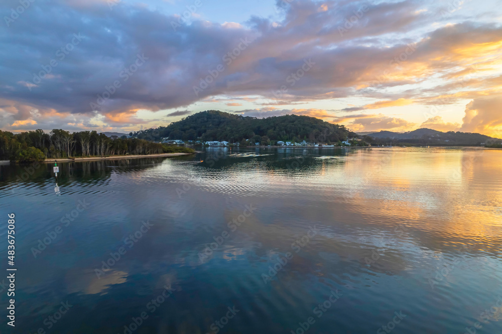 Aerial sunrise over the bay with clouds and reflections