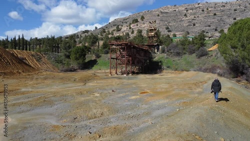 A photographer walks towards the Mitsero Mines, investigating the Mitsero Murders. photo