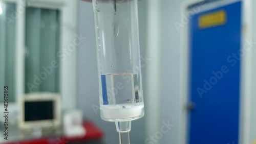 IV intravenous drip fluid hydration medical setup in a hospital clinic, close up of drip with fluid measurements photo