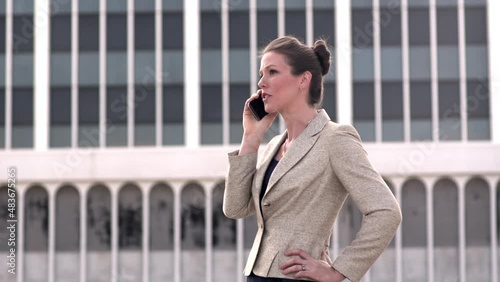 Sharp Businesswoman having phone conversation outdoors
