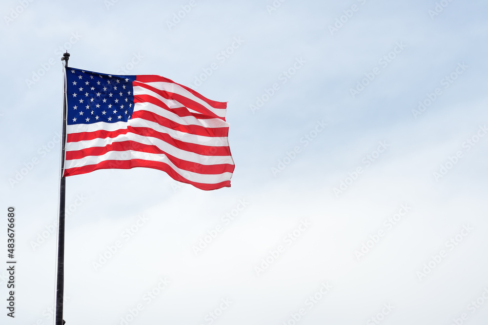 USA flag on blue sky. The star-spangled American flag.