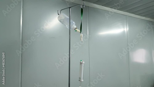 Hydration IV intravenous fluid drip with NaCI sodium chloride setup in a sterile hospital clinic for the next patient photo