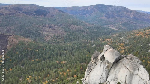 Drone shot panning from right to left over Sugarloaf rock in Kyburz, Ca in El Dorado county. Caldor Wildfire burn scar can be seen in the surrounding forest. photo